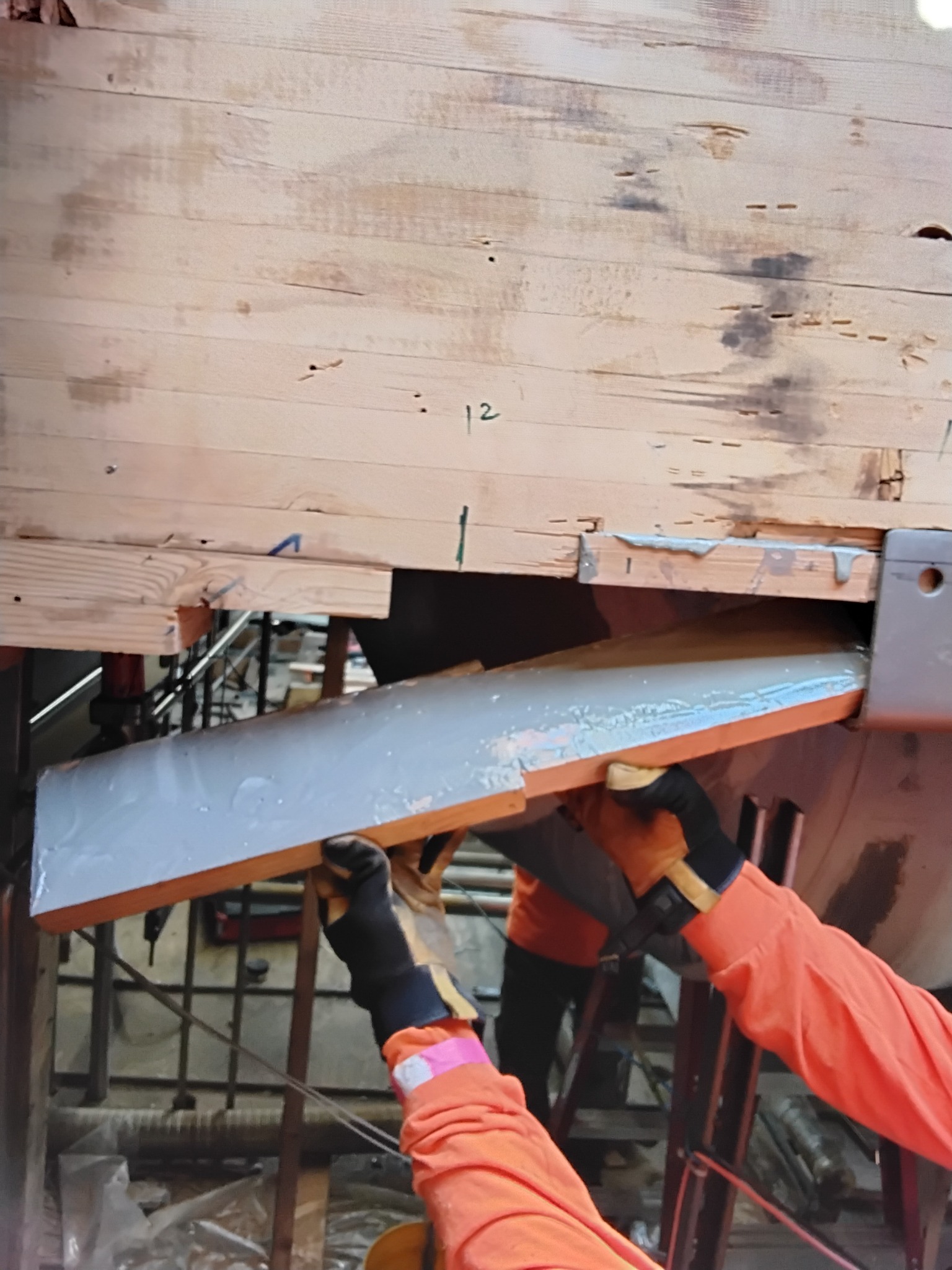 SPS worker repairing a glu-lam beam with epoxy