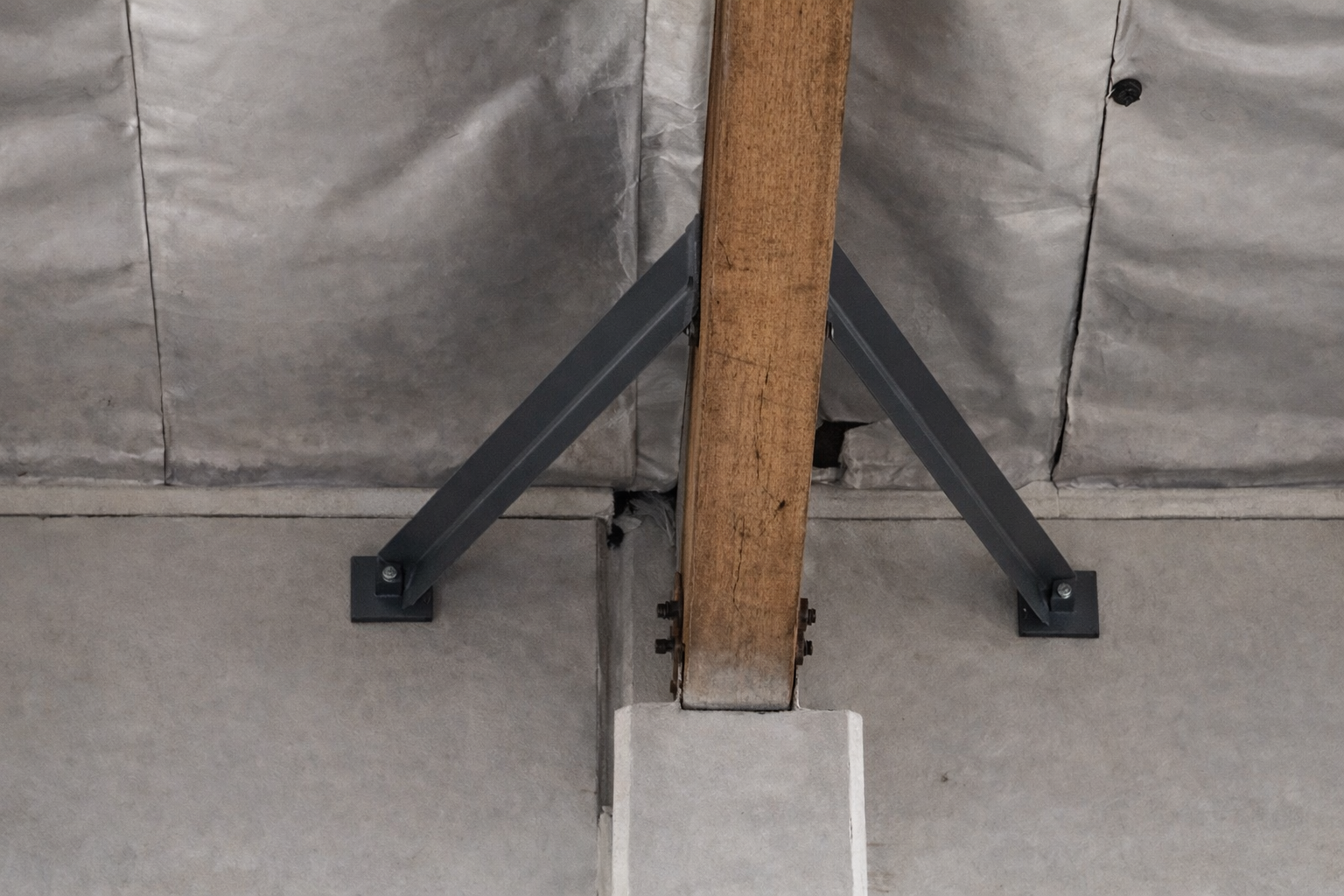 Fabricated seismic connection between a wood beam and wall